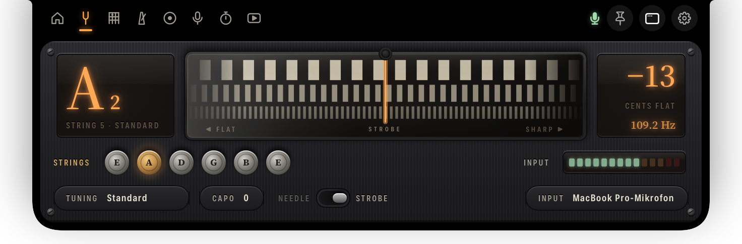 The tuner in strobe mode: three rows of bands behind glass, geared one, two and four times, beside the note display.